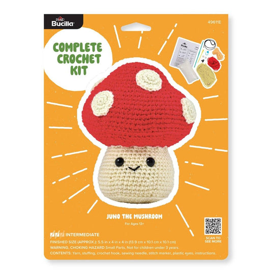 Bucilla Juno the Mushroom crochet kit packaging showing finished red and cream mushroom plush with smiling face