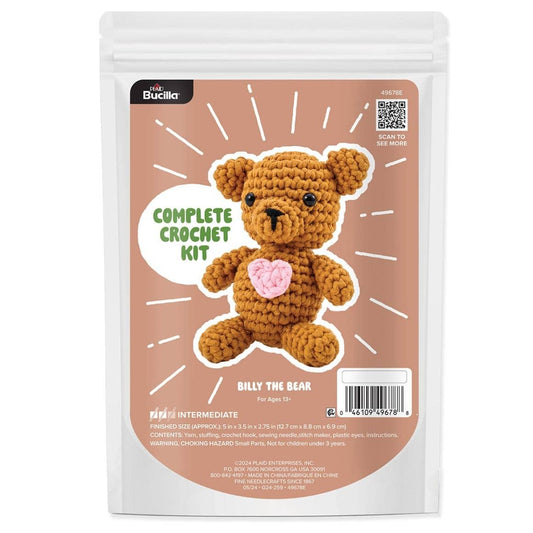 Bucilla crochet animal kit with brown crocheted bear holding a pink heart for intermediate crafters