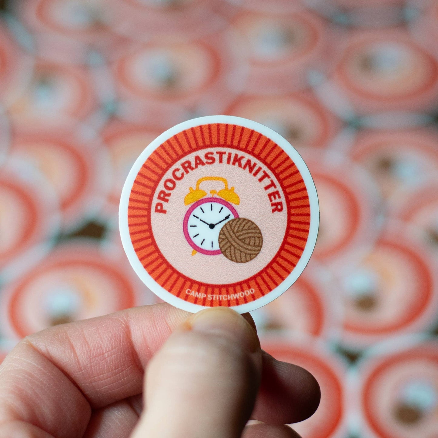 ProcrastiKnitters sticker from Camp Stitchwood showcasing a clock and yarn with camp merit badge requirements