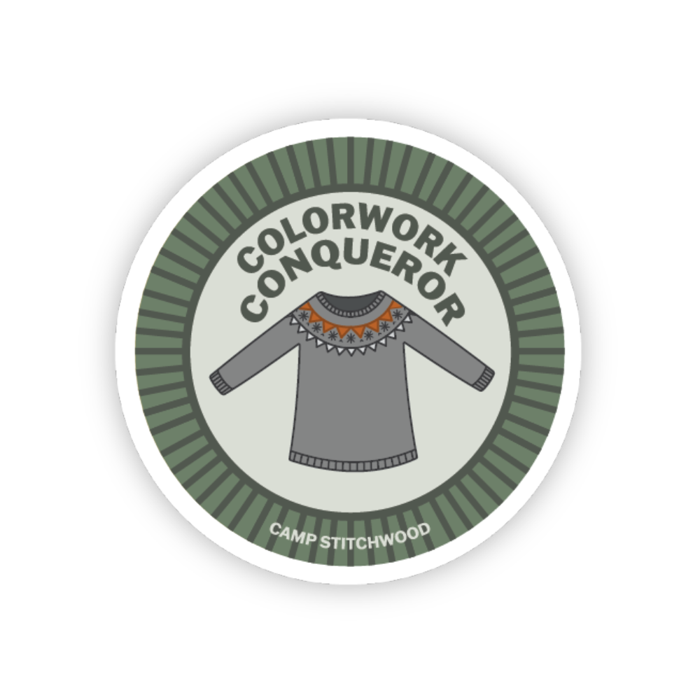 Colorwork knitting badge featuring a sweater design, labeled 'Colorwork Conqueror' by Camp Stitchwood