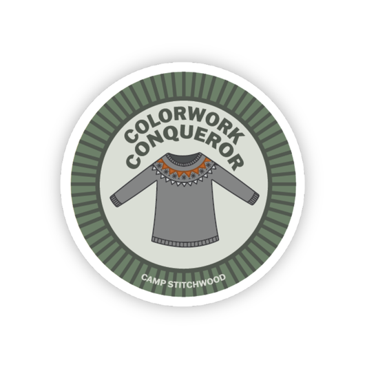 Colorwork knitting badge featuring a sweater design, labeled 'Colorwork Conqueror' by Camp Stitchwood