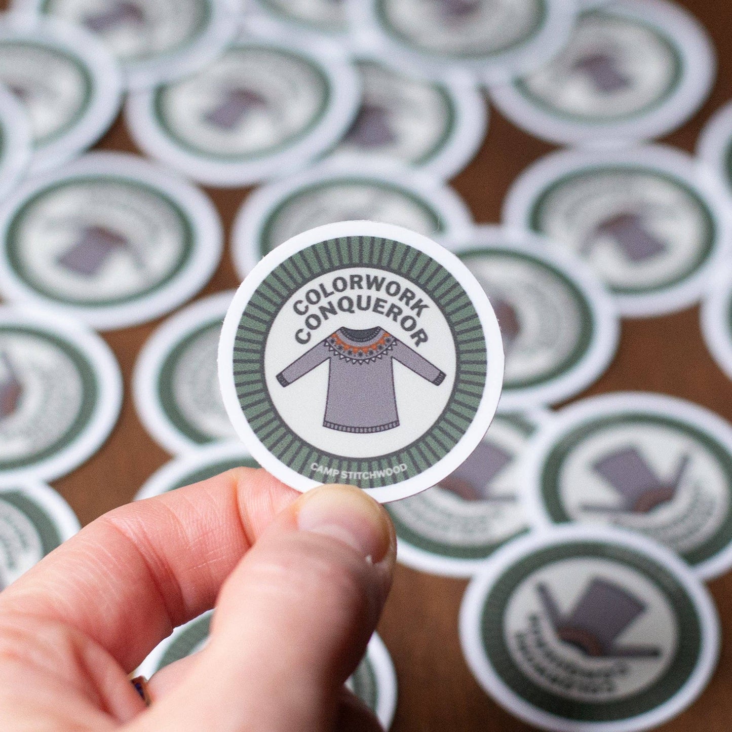 Camp Stitchwood Colorwork Knitting Sticker featuring a sweater design and text 'Colorwork Conqueror'