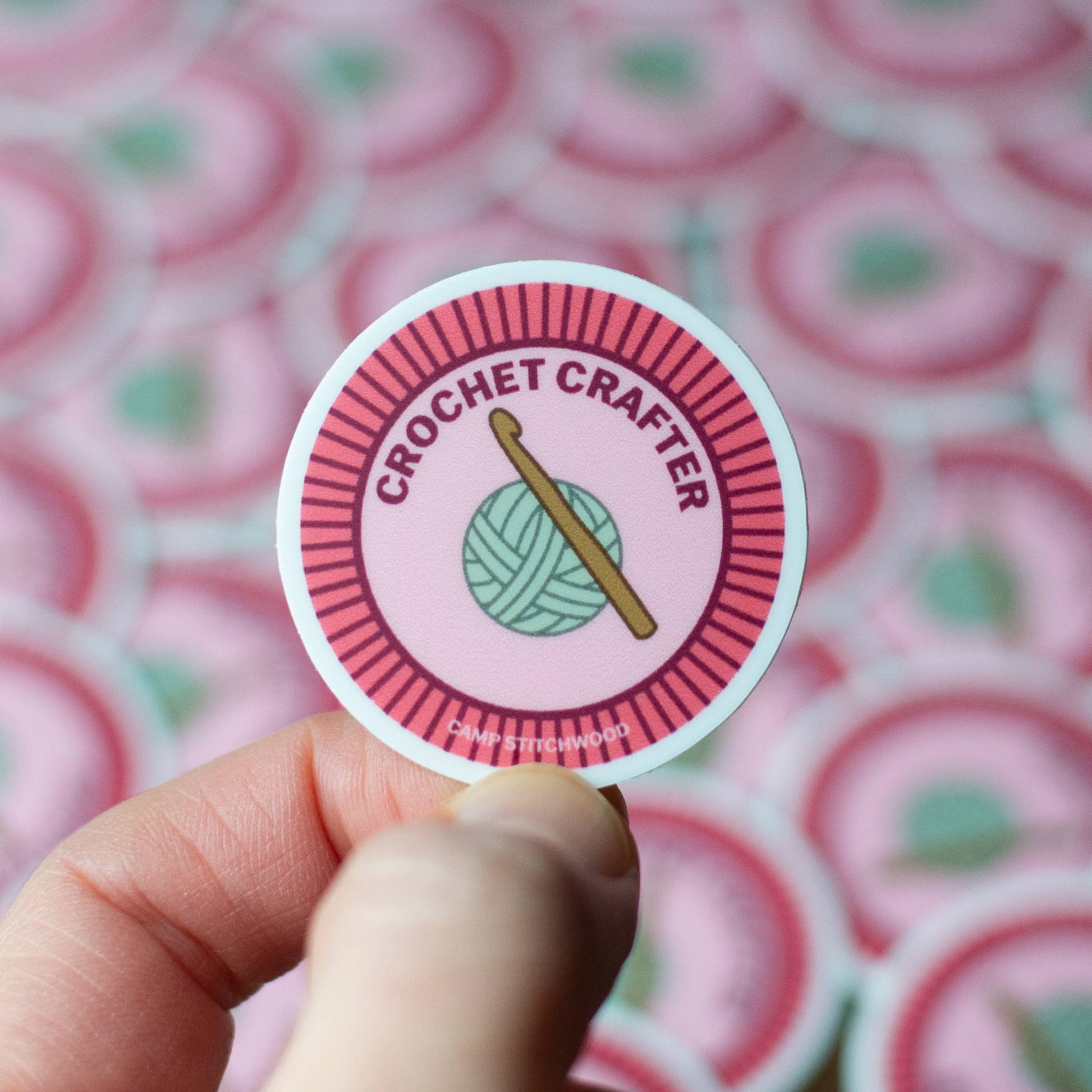 Hand holding a cs2 sticker craft maker featuring a crochet theme with yarn and hook design