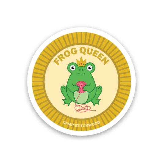 Camp Stitchwood Frog Queen name badge sticker featuring a playful frog holding yarn