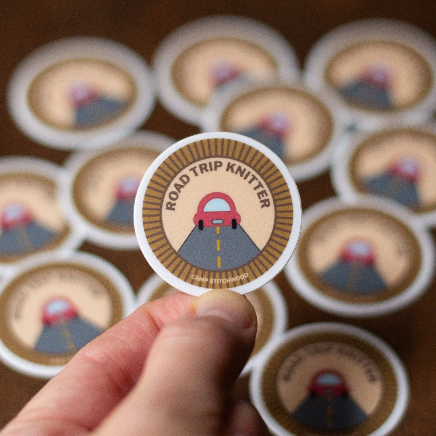 Camp Stitchwood Road Trip Knitter sticker featuring a car and road design for knitting enthusiasts
