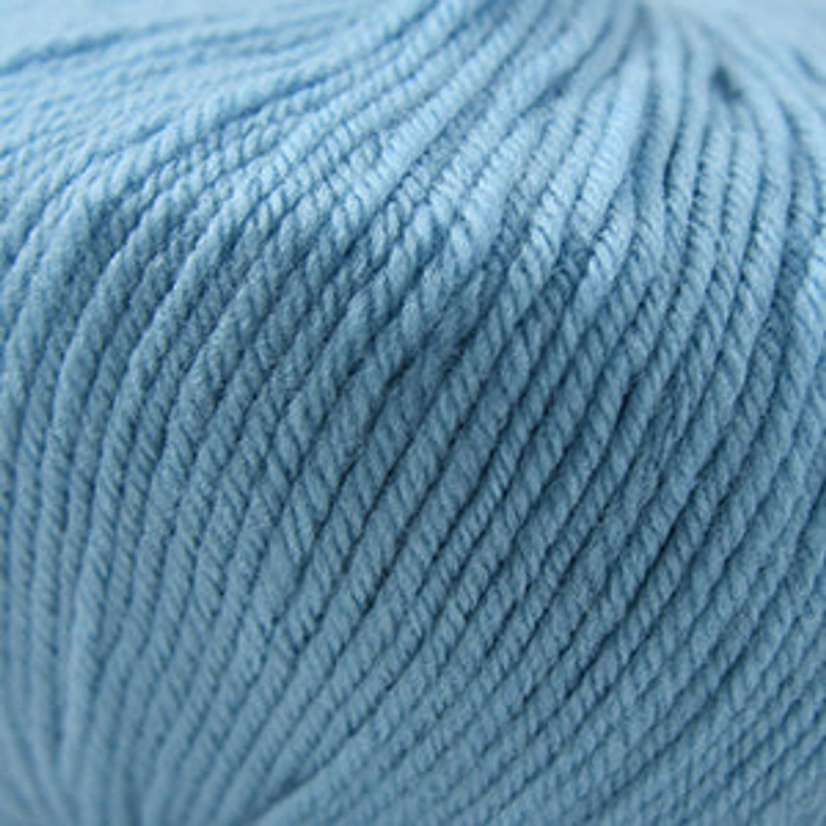 Close-up of Cascade Yarns 220 Superwash wool in a soft blue shade for knitting and crochet projects