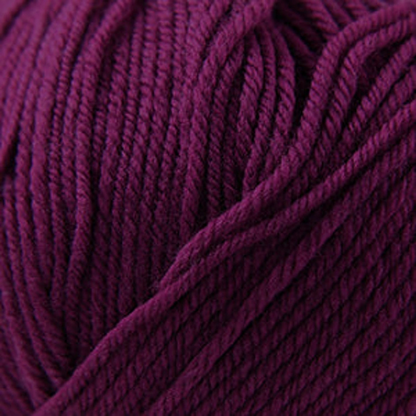 Cascade Yarns 220 Superwash wool in deep purple, ideal for versatile knitting projects