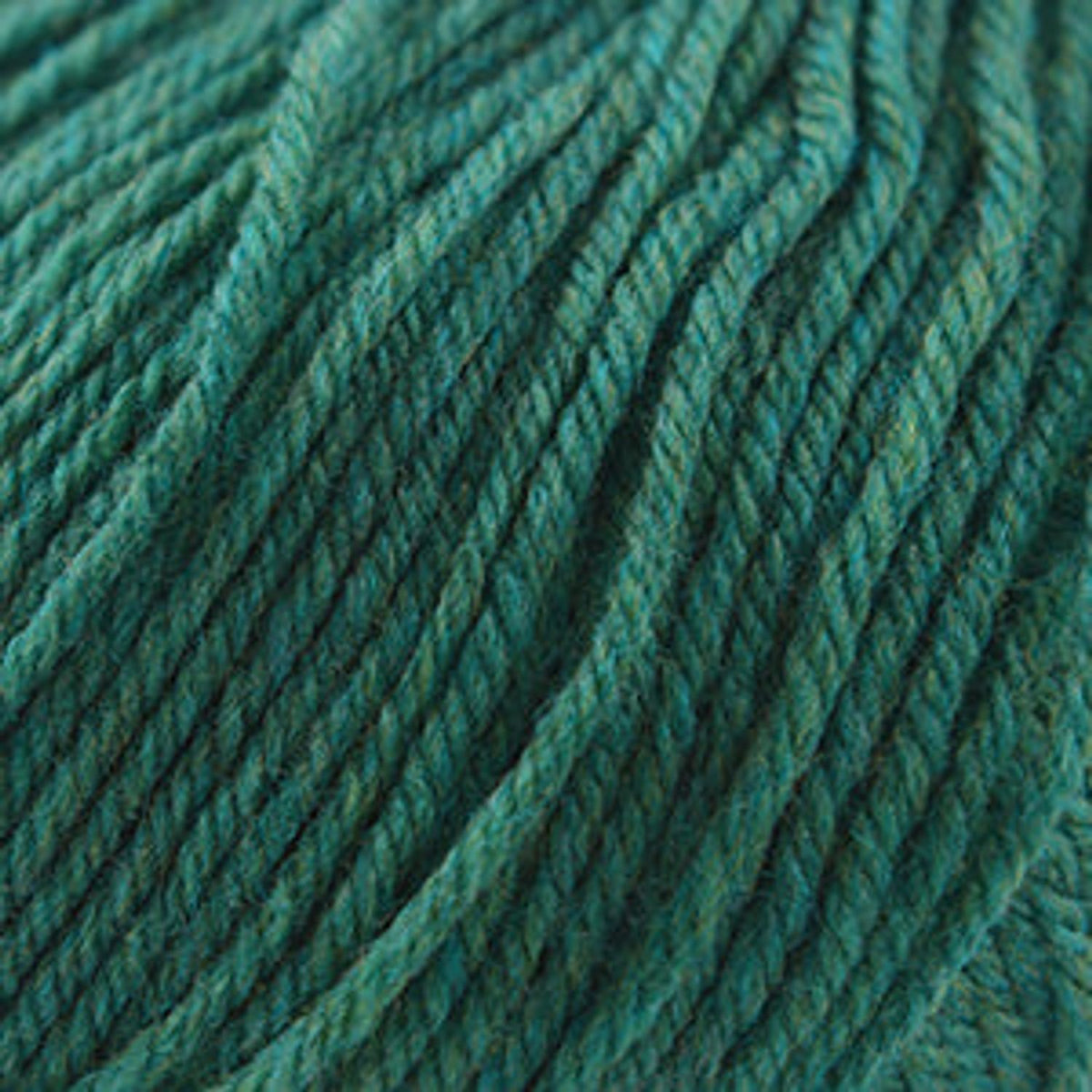 Close-up of Cascade Yarns 220 Superwash wool in a rich teal color with smooth texture