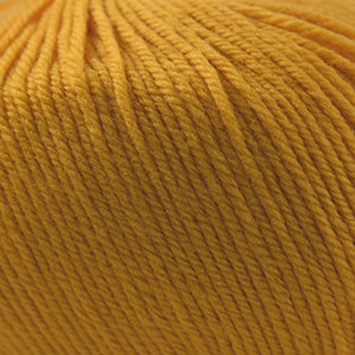 Close-up of Cascade Yarns 220 Superwash wool in vibrant yellow color for knitting and crocheting projects