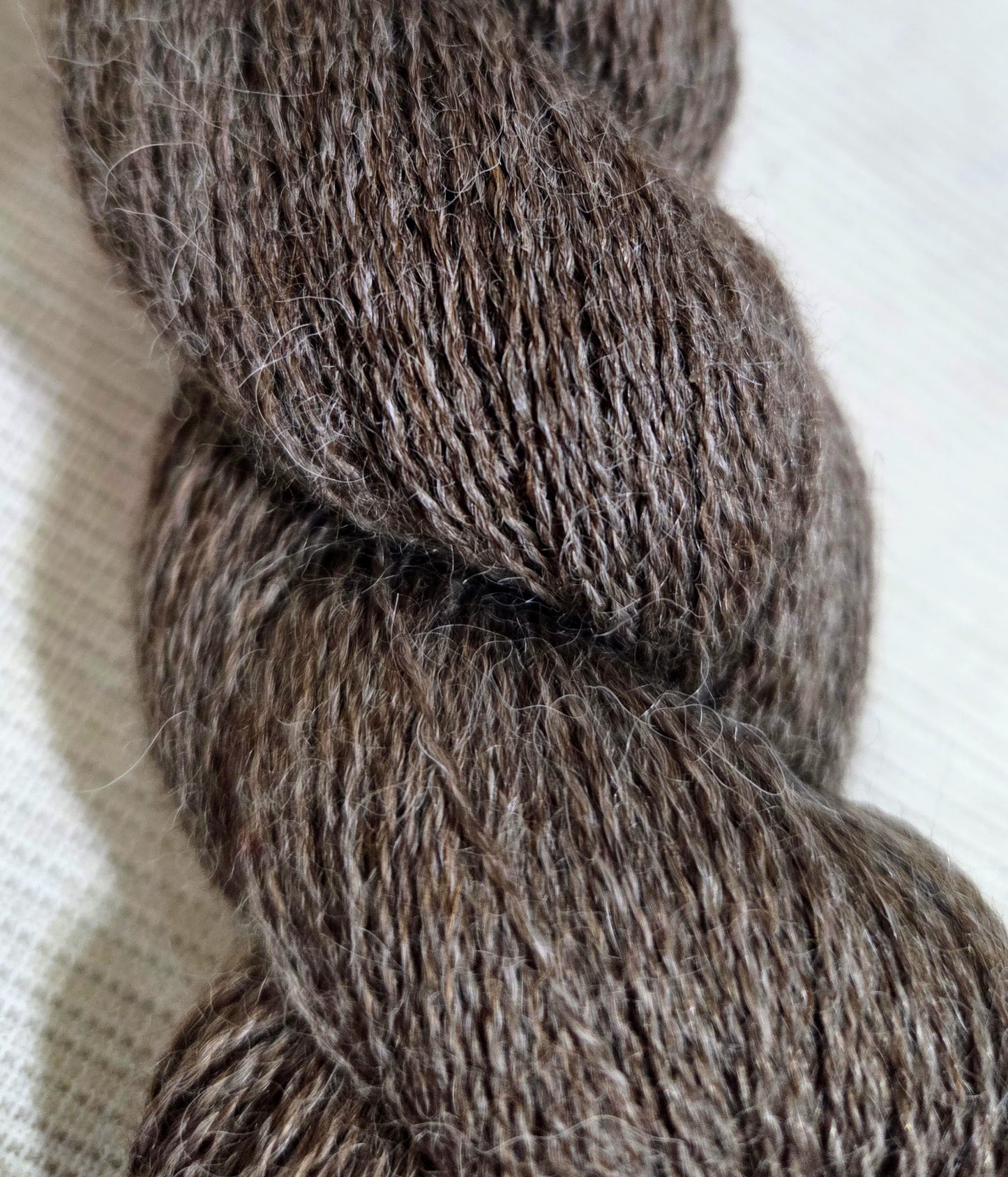 Cascade Yarns Alpaca Lace Yarn in warm brown hues, ideal for delicate knitting projects