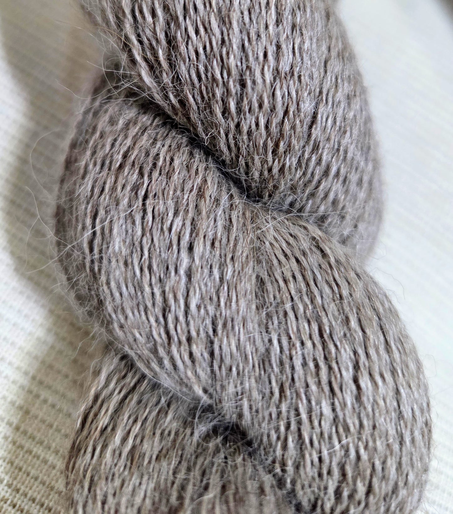 Cascade Yarns Alpaca Lace in a soft grey hue, perfect for delicate knitting projects