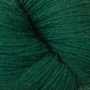 Close-up of Cascade Yarns Heritage superwash merino wool in deep green color, perfect for knitting and crochet projects