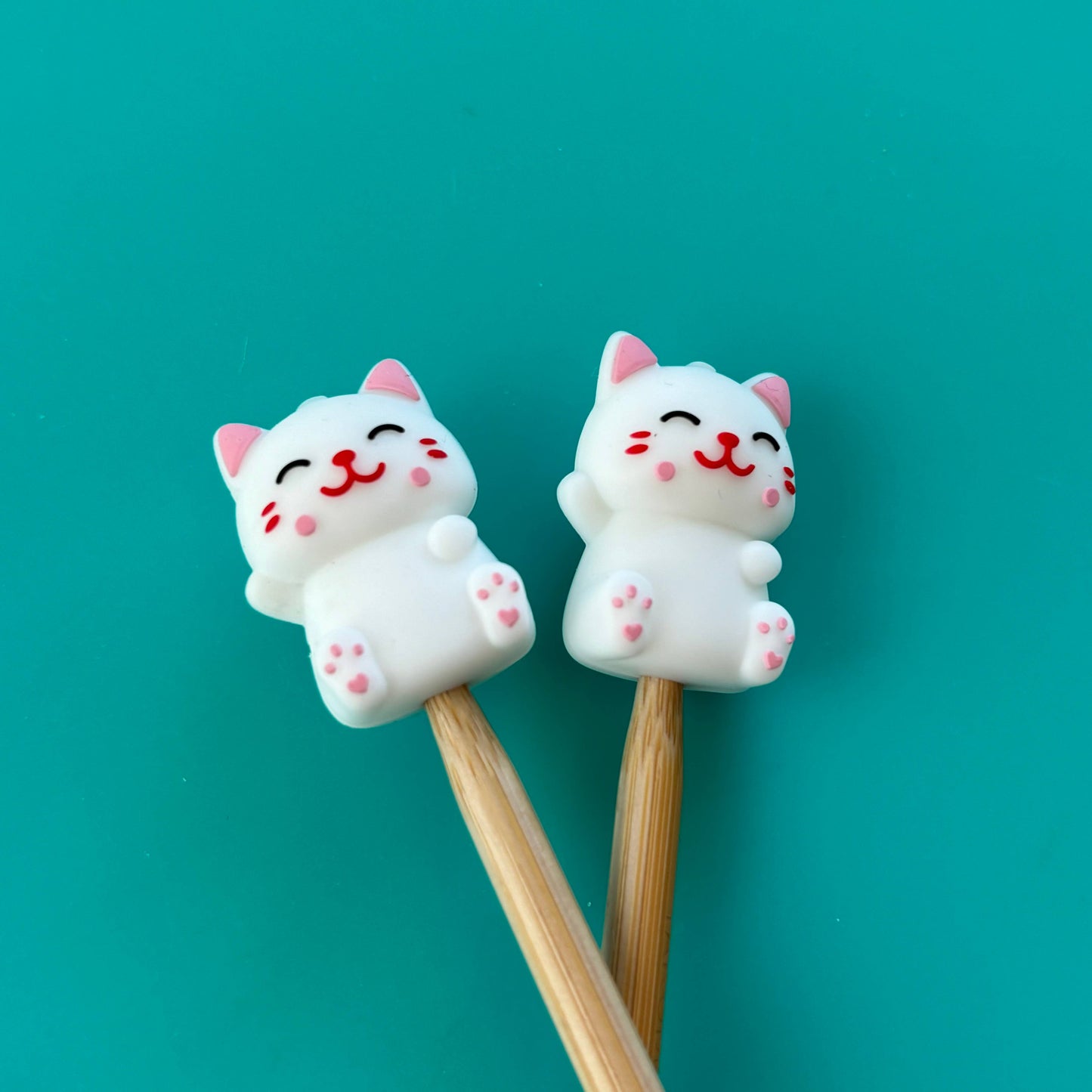 Cute cat chopsticks with smiling face and pink accents for fun dining experiences