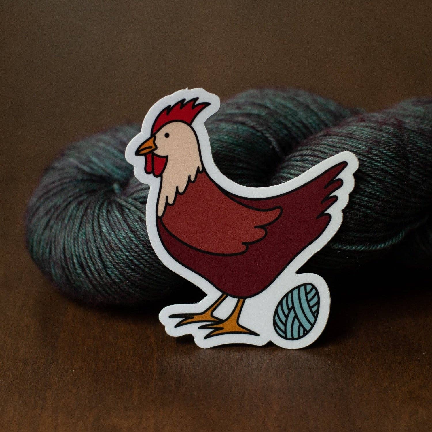 Camp Stitchwood Chicken Sticker with Yarn Ball, perfect for craft and animal lovers, showcasing vibrant colors