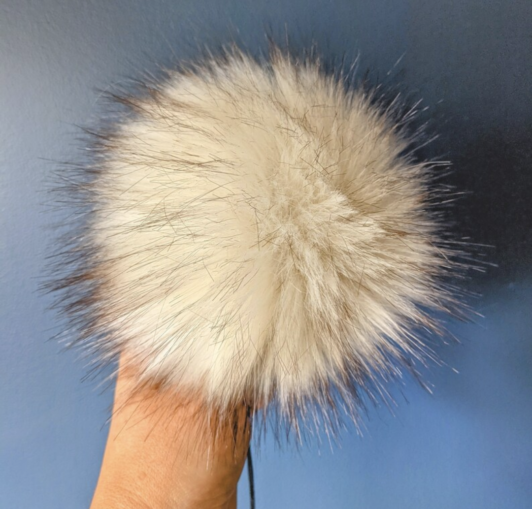 Fluffy White countrystixco pom pom accessory for adding a stylish touch to bags and clothing