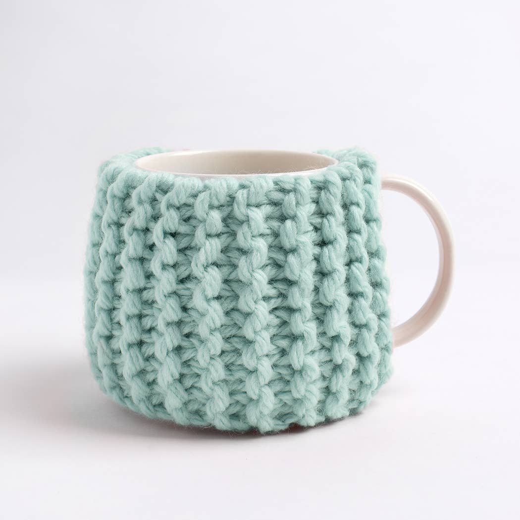 Wool Couture Company beginner knitting kit for cup cozy shown as mint chunky textured mug cozy