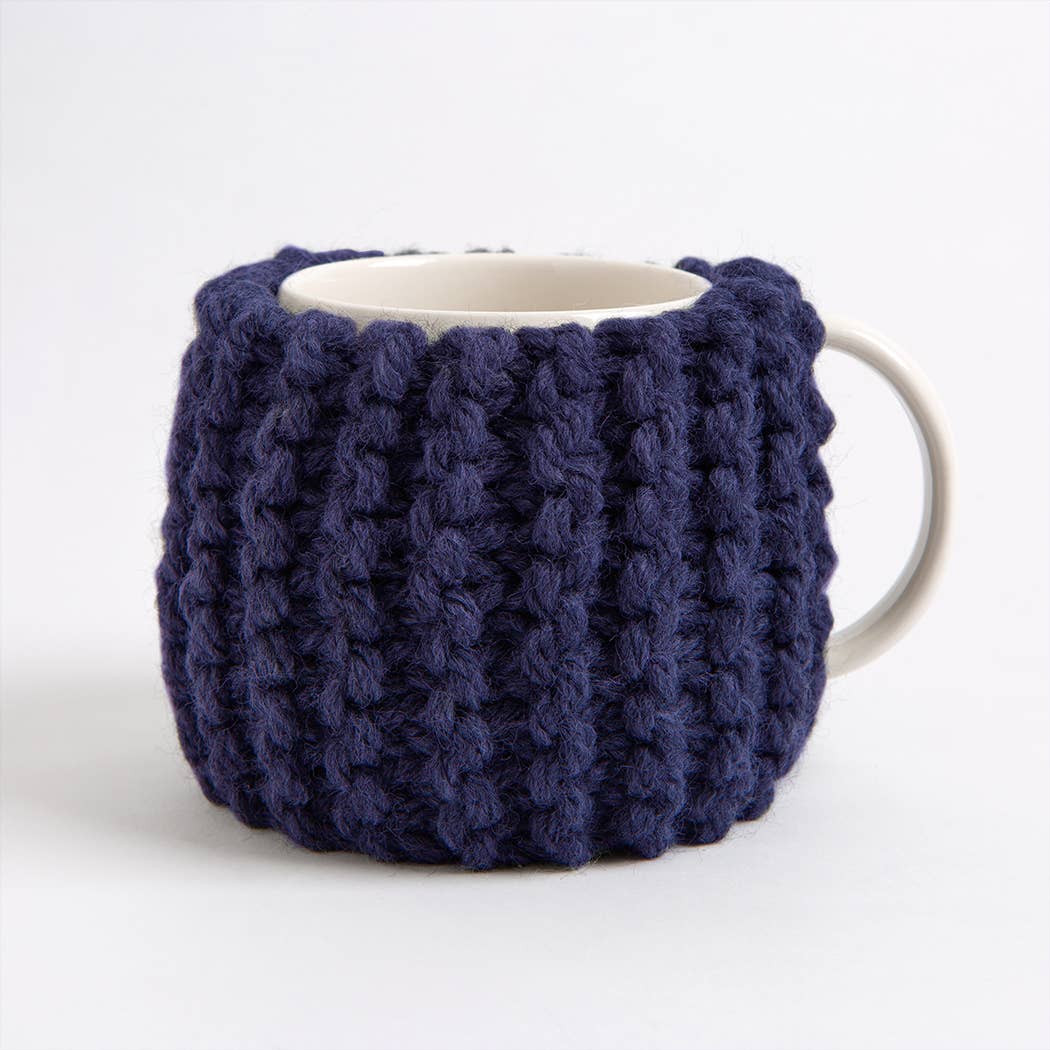Wool Couture Company navy chunky knit mug cozy on white ceramic cup beginner knitting kit for cup cozy