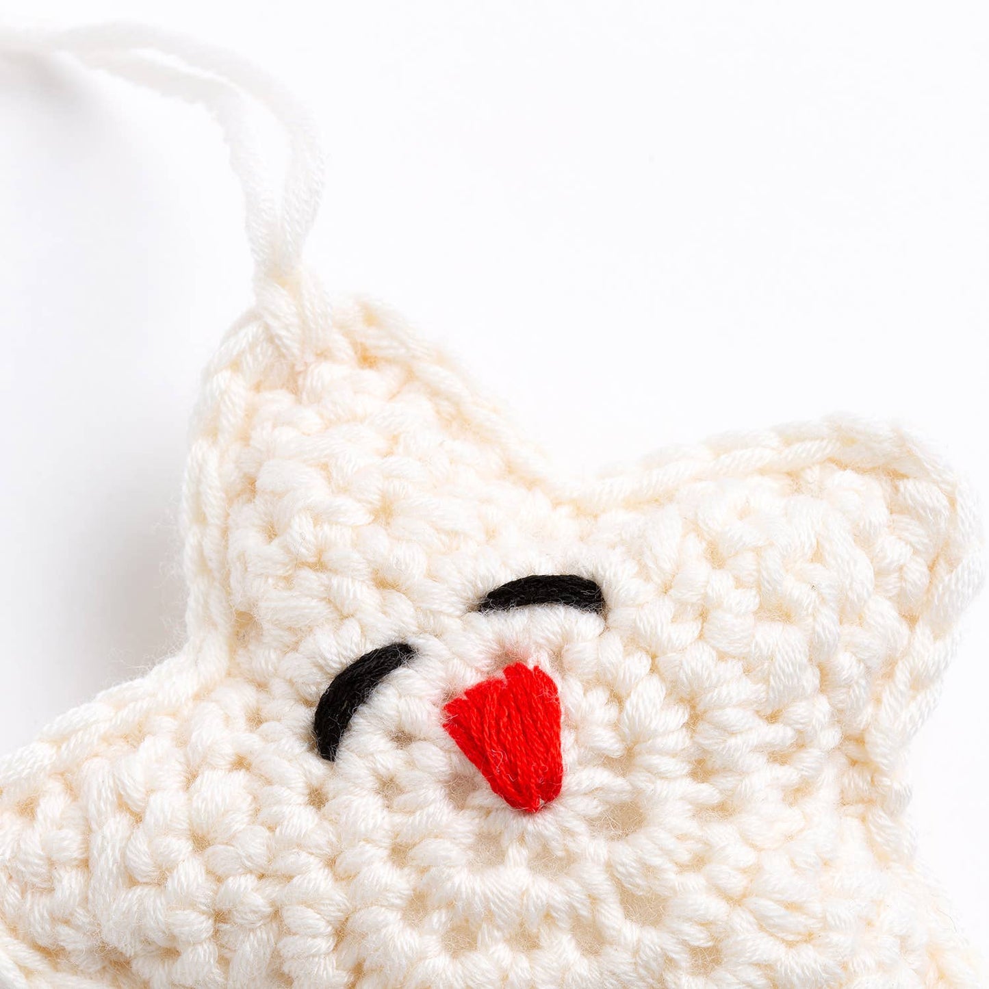 Belle the Reindeer crochet pattern cream crocheted ornament with red embroidered nose black sleepy eyes and hanging loop