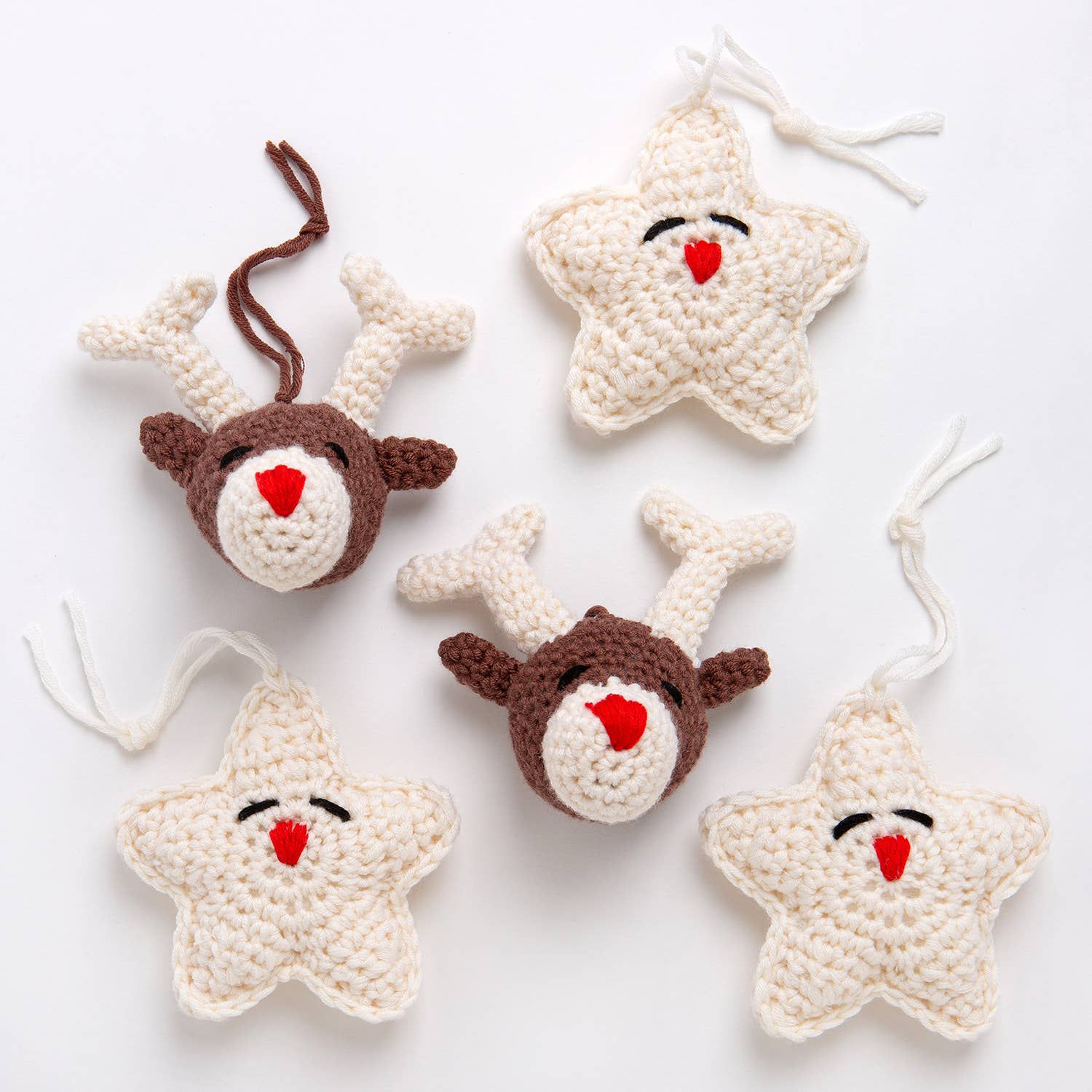 Handmade cream star ornaments and brown reindeer head ornaments with red noses and loops Belle the Reindeer crochet pattern