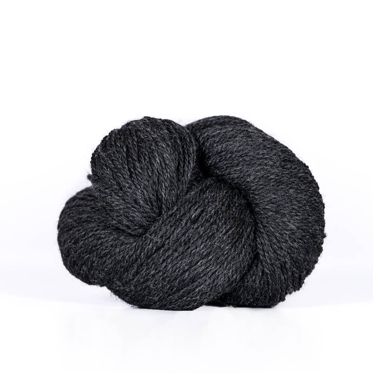 Kelbourne Woolens dark charcoal skein of fingering weight 100% wool yarn showing soft twisted texture