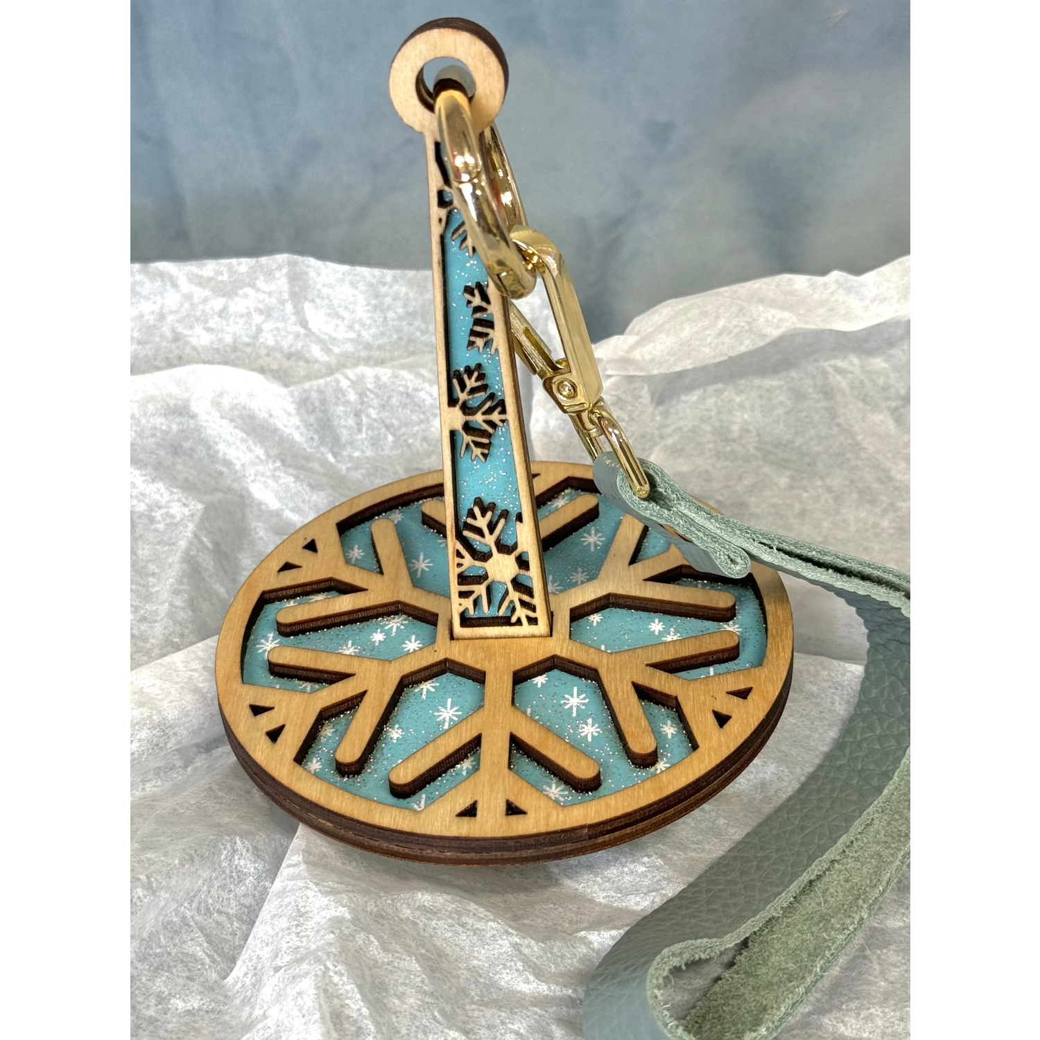 lemonwood snowflake yarn holder laser cut wood snowflake with teal fabric inlay and gold swivel clip wrist strap
