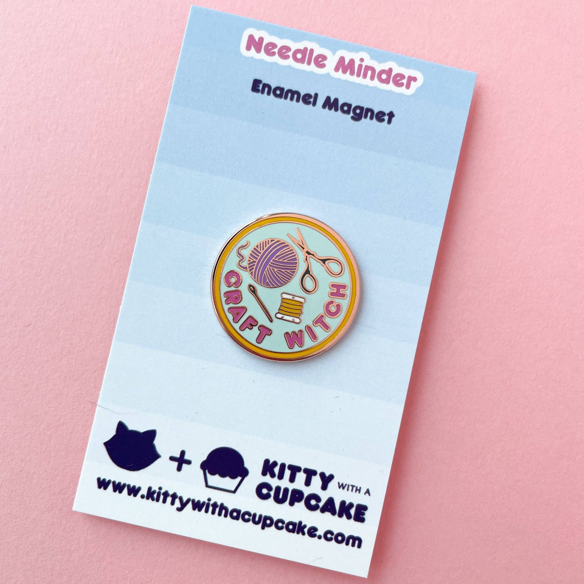 Enamel needle minder featuring yarn and scissors with the phrase witch-craft for crafting enthusiasts