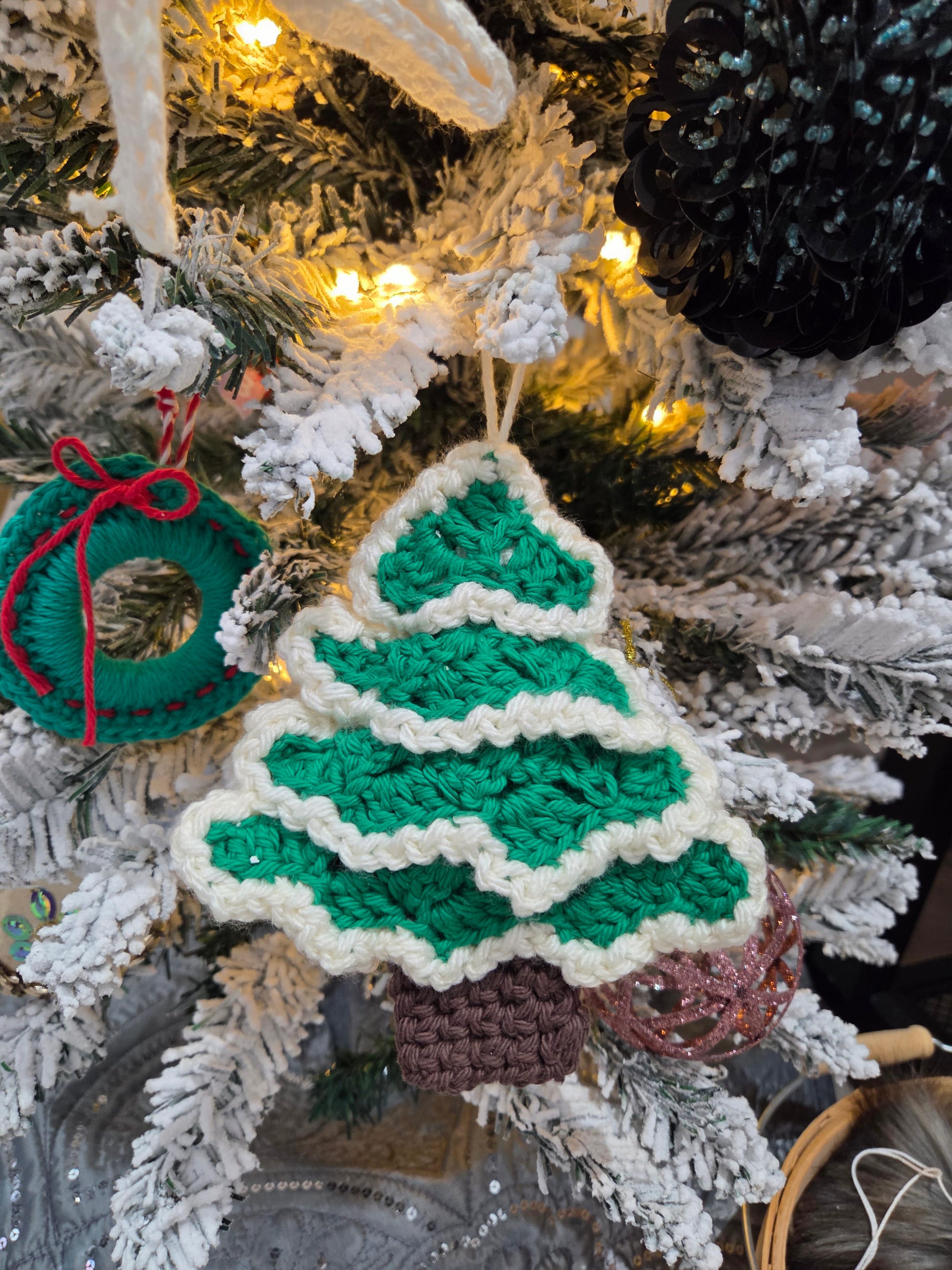 Crochet Christmas tree ornament workshop project featuring a green tree design with a brown pot