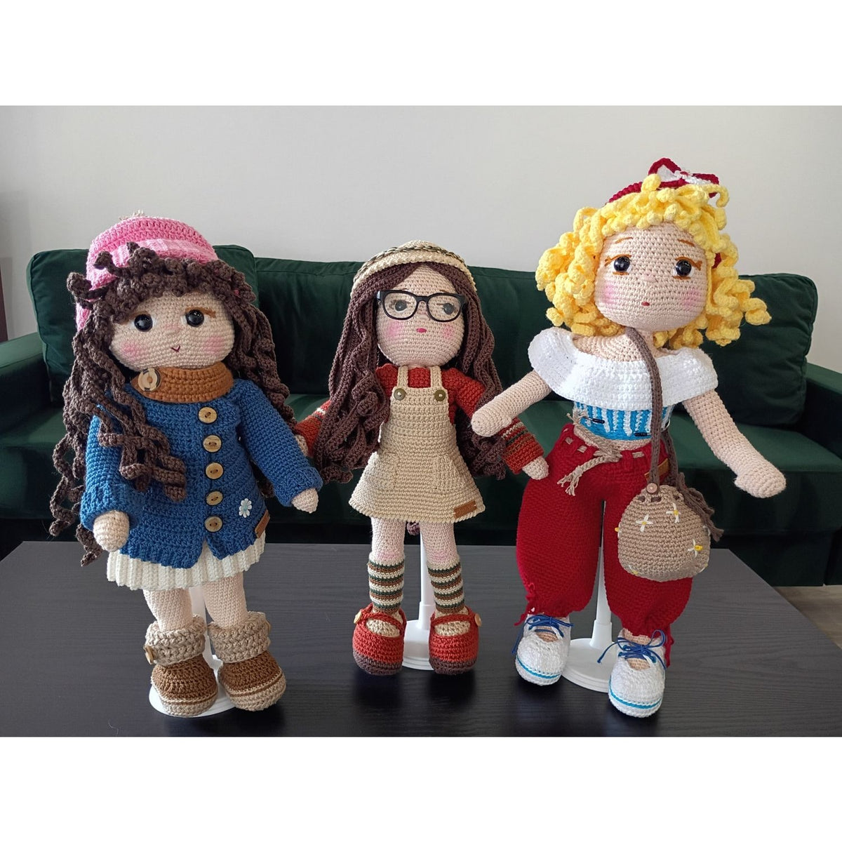 Three crochet dolls in stylish outfits showcasing handmade details by Genny's Crochet