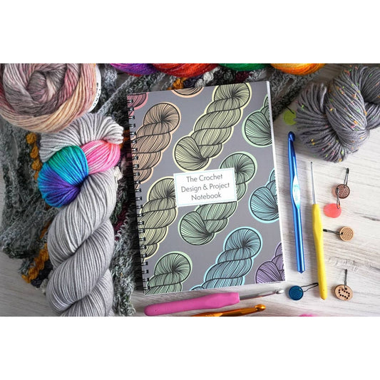 Crochet project journal for patterns with colorful yarn, crochet hooks, and stitch markers by Bri Larson Art
