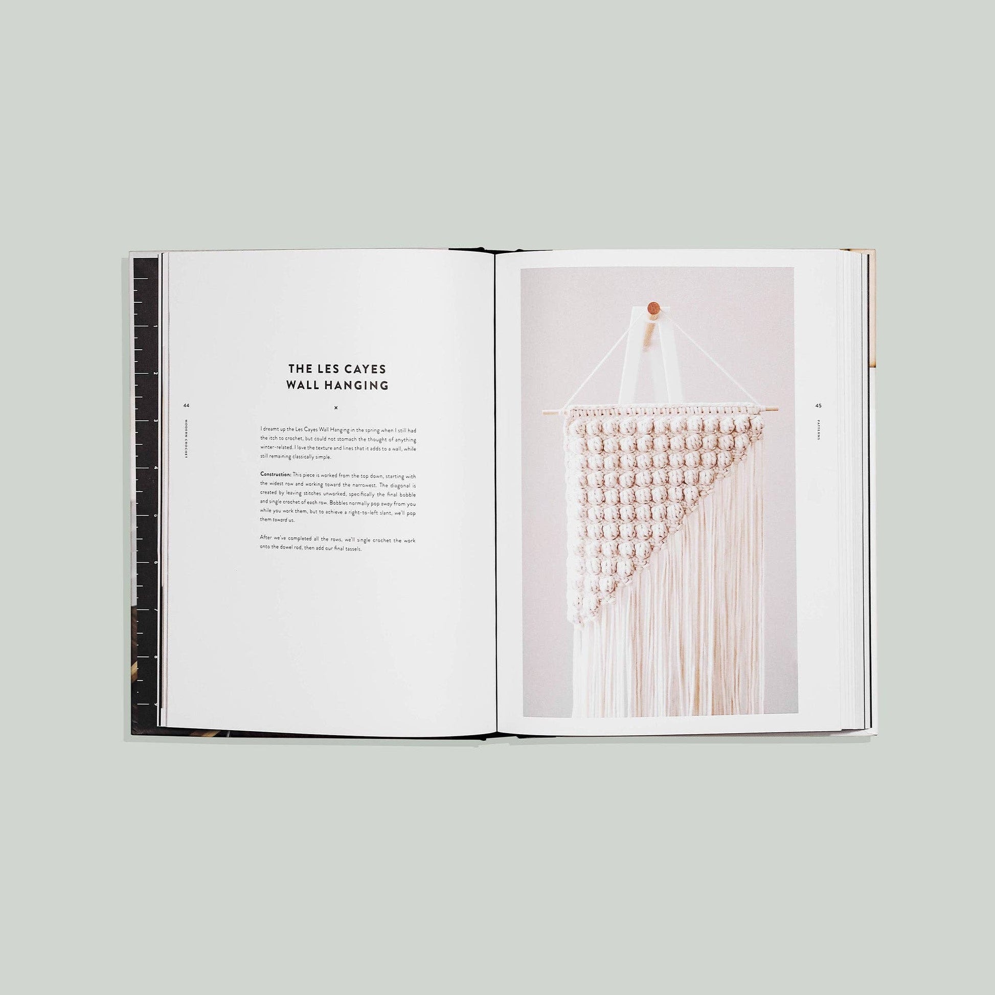 Open modern crochet patterns book showcasing a wall hanging design with detailed instructions