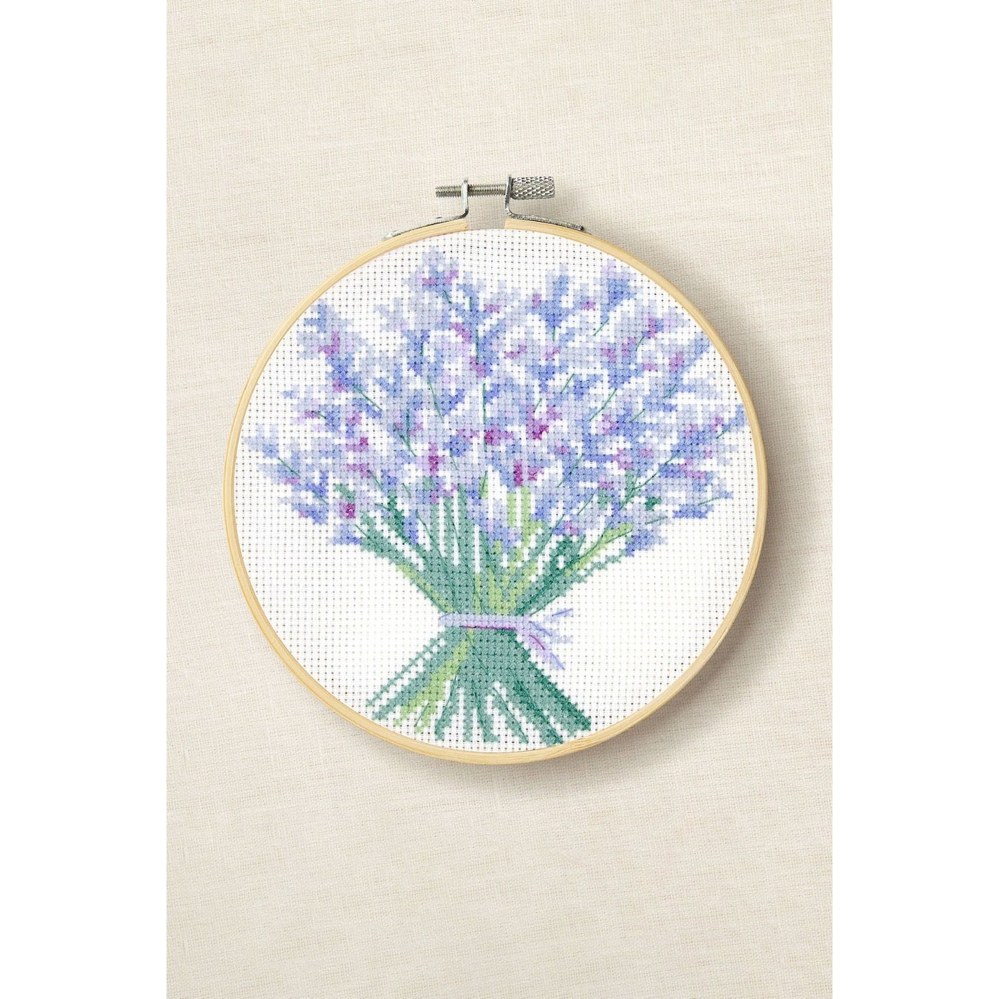 DMC cross-stitch kit featuring a bouquet of lavender in a wooden hoop for crafting enthusiasts