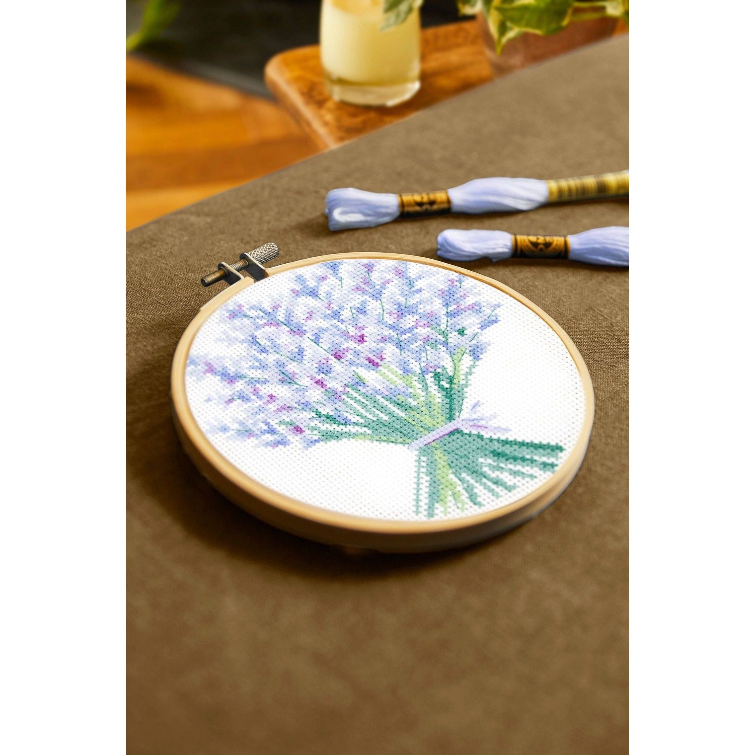 DMC cross-stitch kit featuring a lavender bouquet design with vibrant colors and included threads