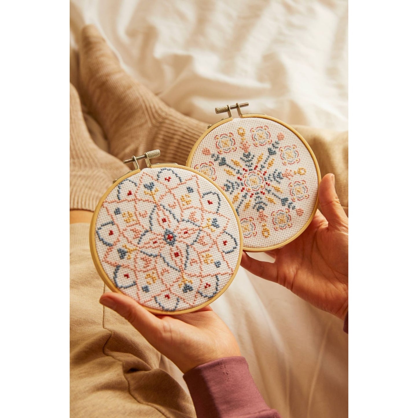 DMC Cross-Stitch Kit showcasing colorful mandala scrubs designs in embroidery hoops