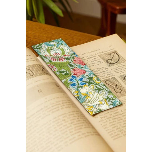 Colorful DMC cross stitch bookmark featuring floral patterns on fabric, perfect for stitch enthusiasts