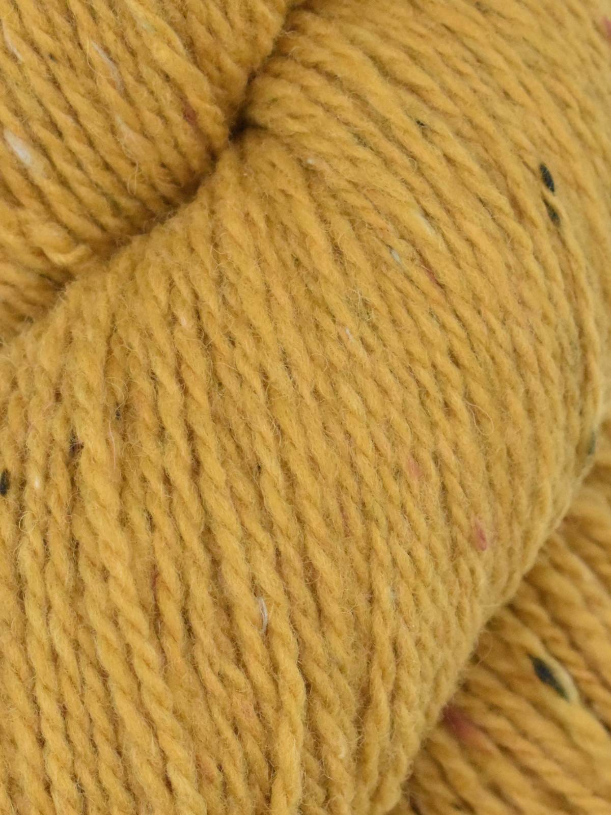 Close-up of Ella Rae Eco Tweed yarn in golden yellow with colorful flecks for knitting projects
