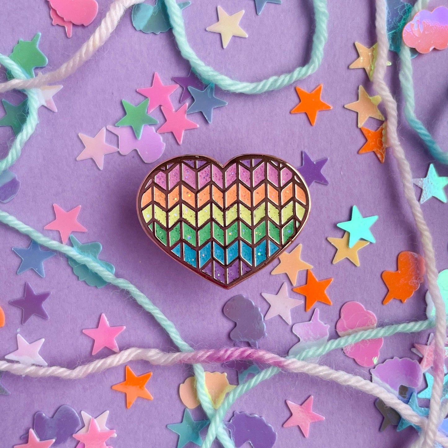 Colorful heart-shaped enamel pin pins with a chevron pattern surrounded by confetti