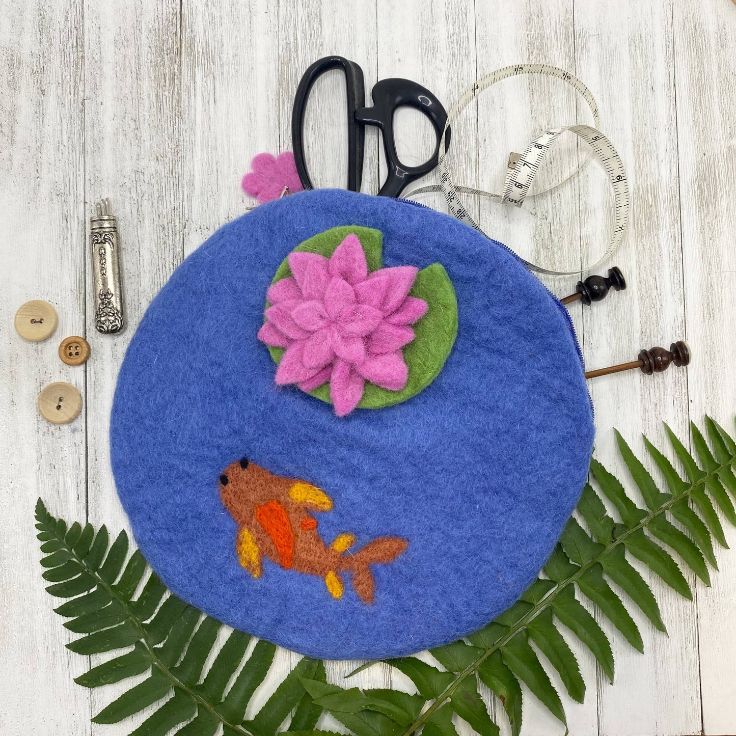 Colorful felt bag with a goldfish design and pink water lilies on a blue background
