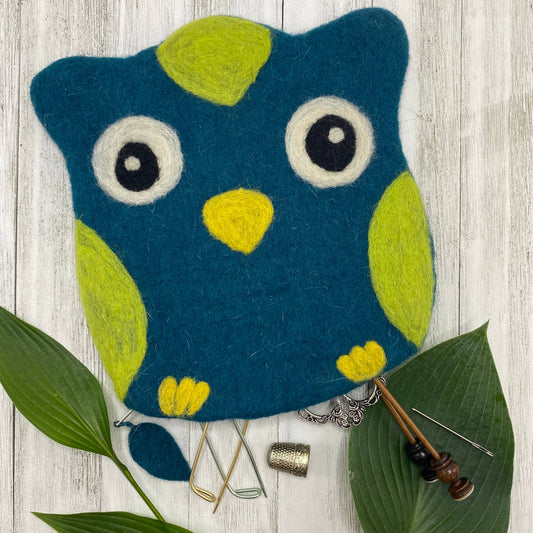 Colorful felt bag shaped like an owl with vibrant blue and green accents for storing crafting tools