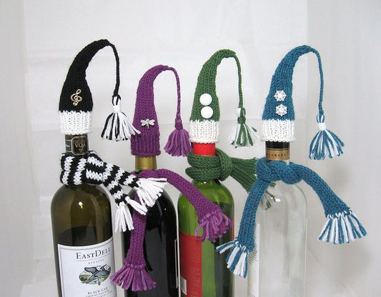 Festive wine bottle decorations workshop featuring knitted caps in various colors and designs