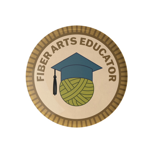 Camp Stitchwood Fiber Arts Educator Badge featuring a graduation cap and yarn ball design