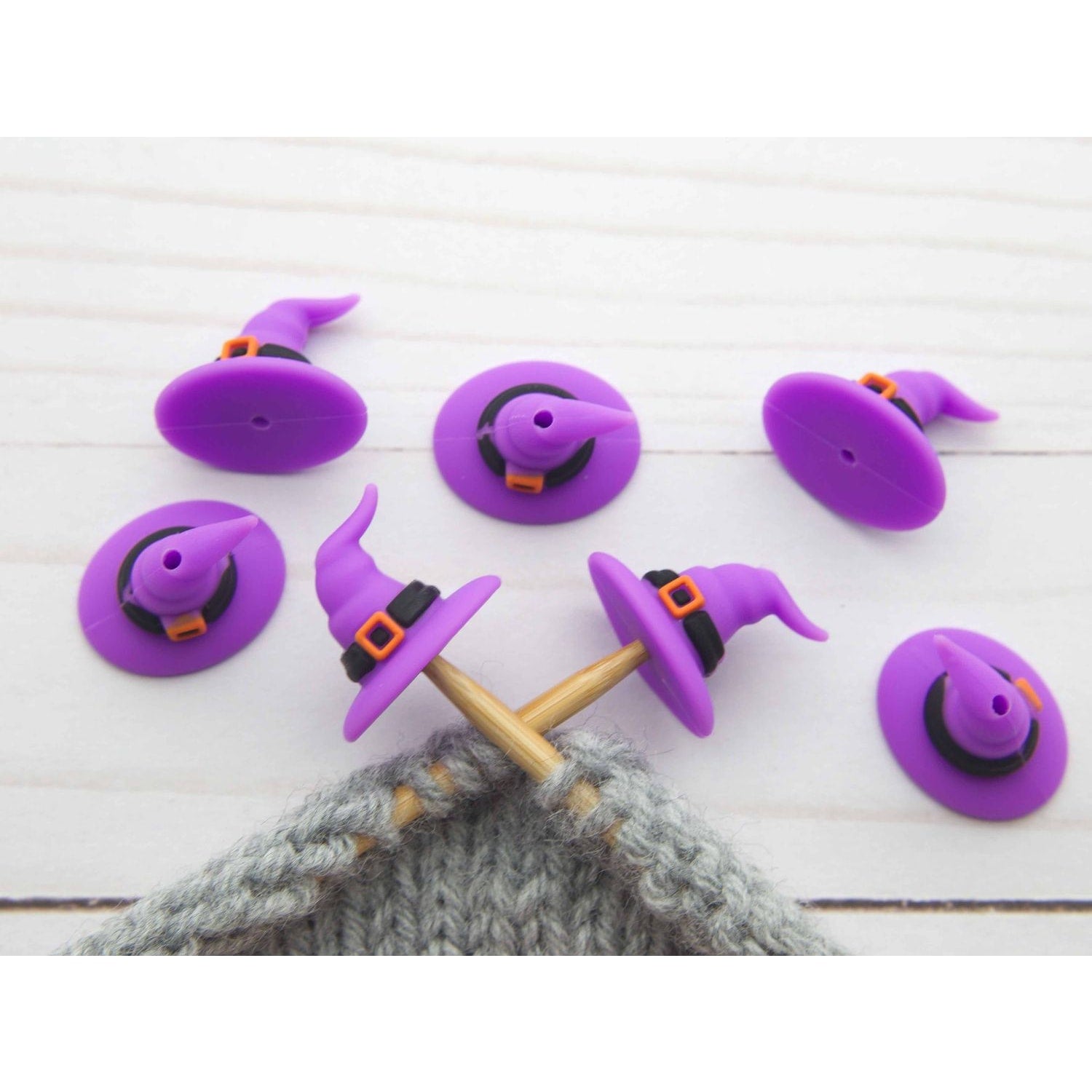 Fox & Pine Stitches stitch stoppers purple witch hat knitting needle caps on gray knitted fabric