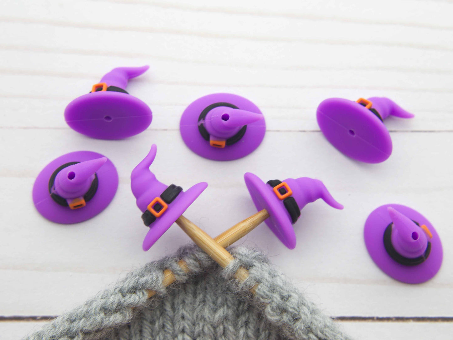 Fox & Pine Stitches stitch stoppers purple witch hat knitting needle caps on gray knitted fabric
