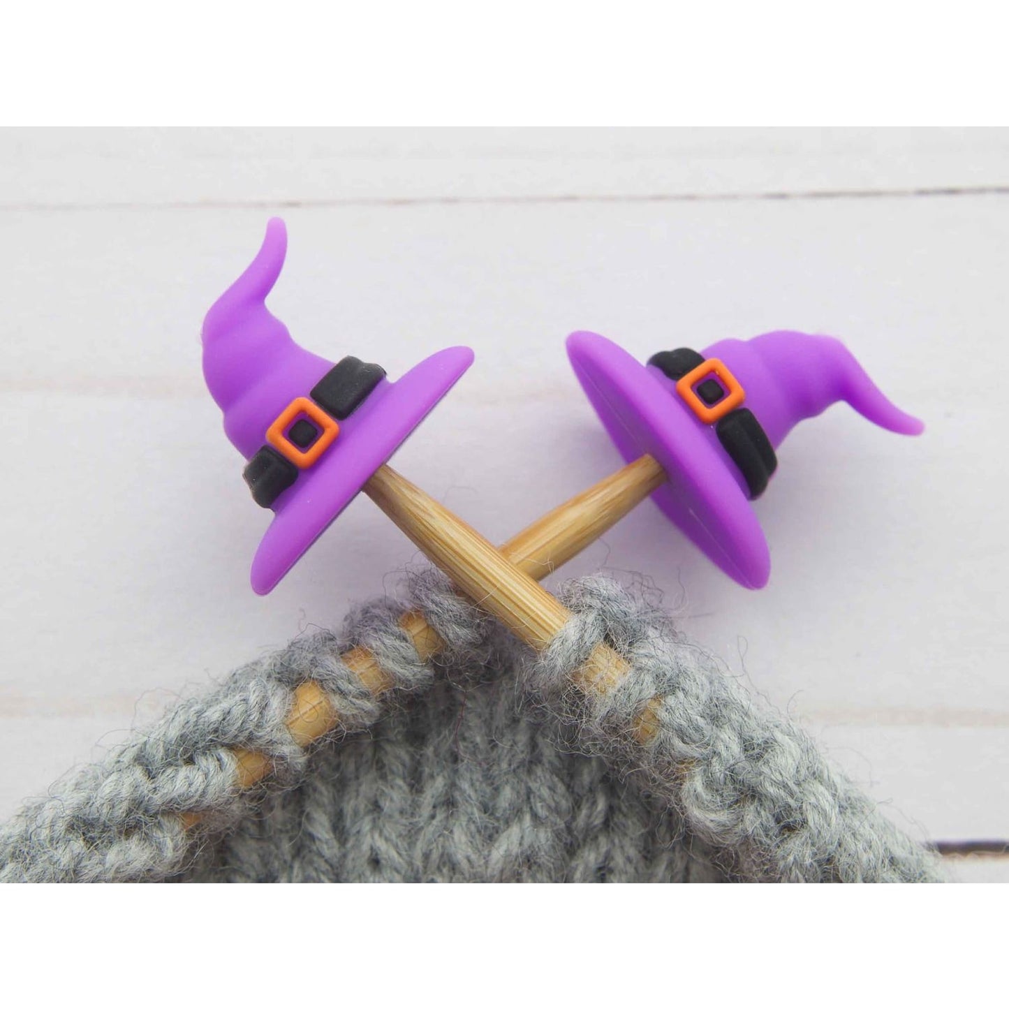 Fox & Pine Stitches stitch stoppers purple witch hat needle caps on bamboo knitting needles with gray yarn