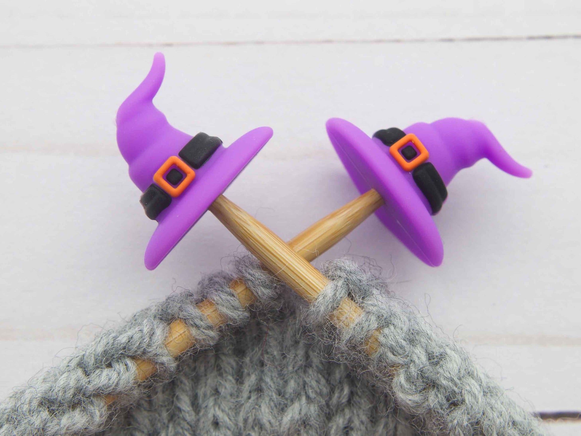 Fox & Pine Stitches stitch stoppers purple witch hat needle caps on bamboo knitting needles with gray yarn