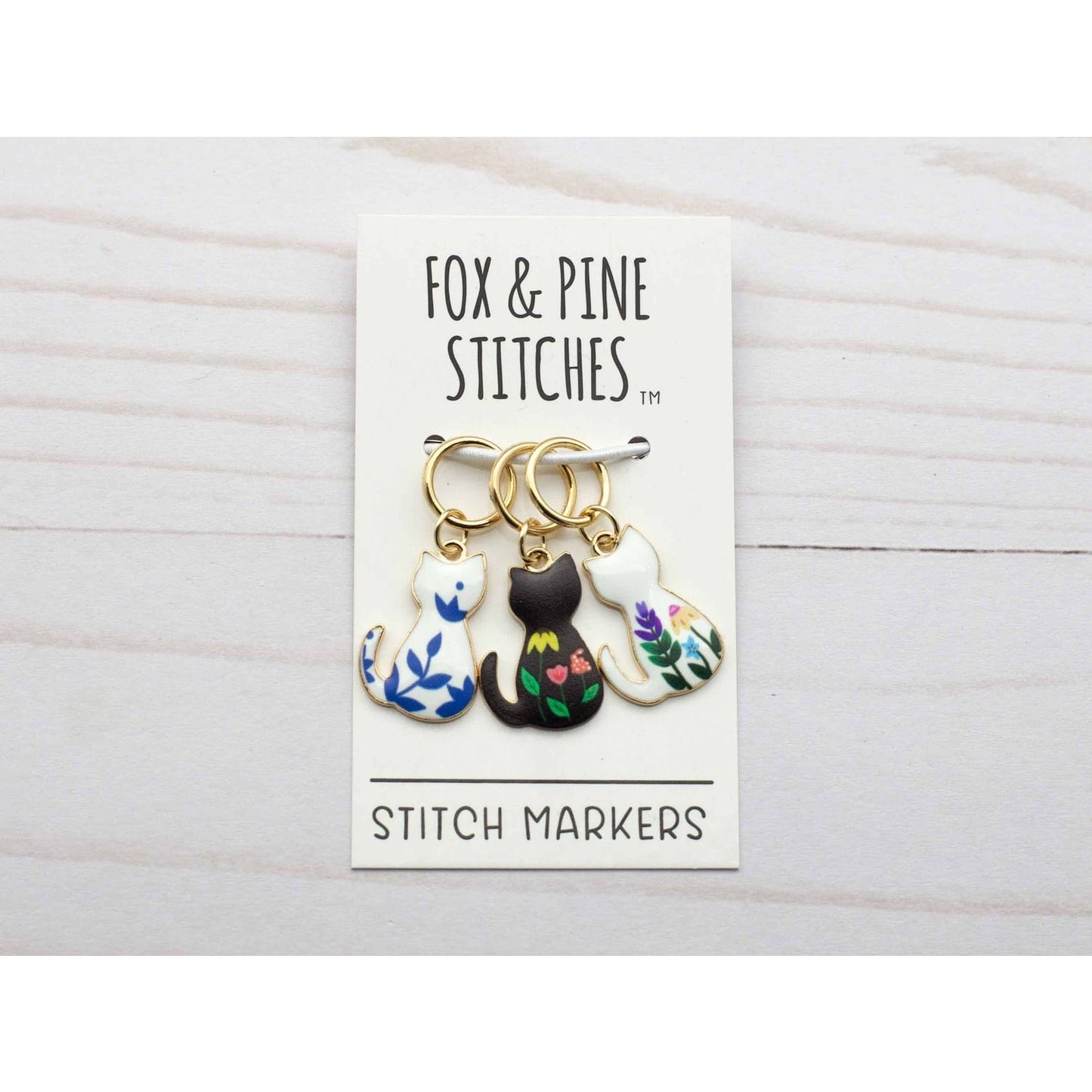 Fox & Pine Stitches cat-themed stitch markers for crocheting in three colors with floral designs
