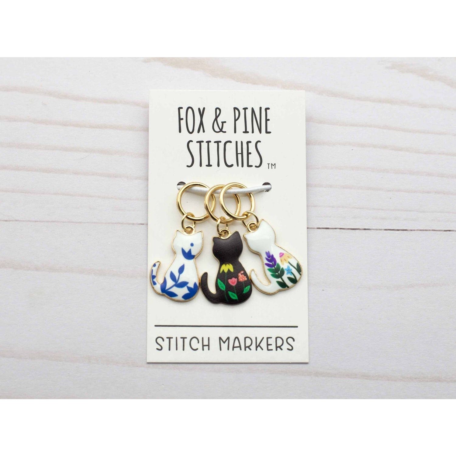 Fox & Pine Stitches cat-themed stitch markers for crocheting in three colors with floral designs