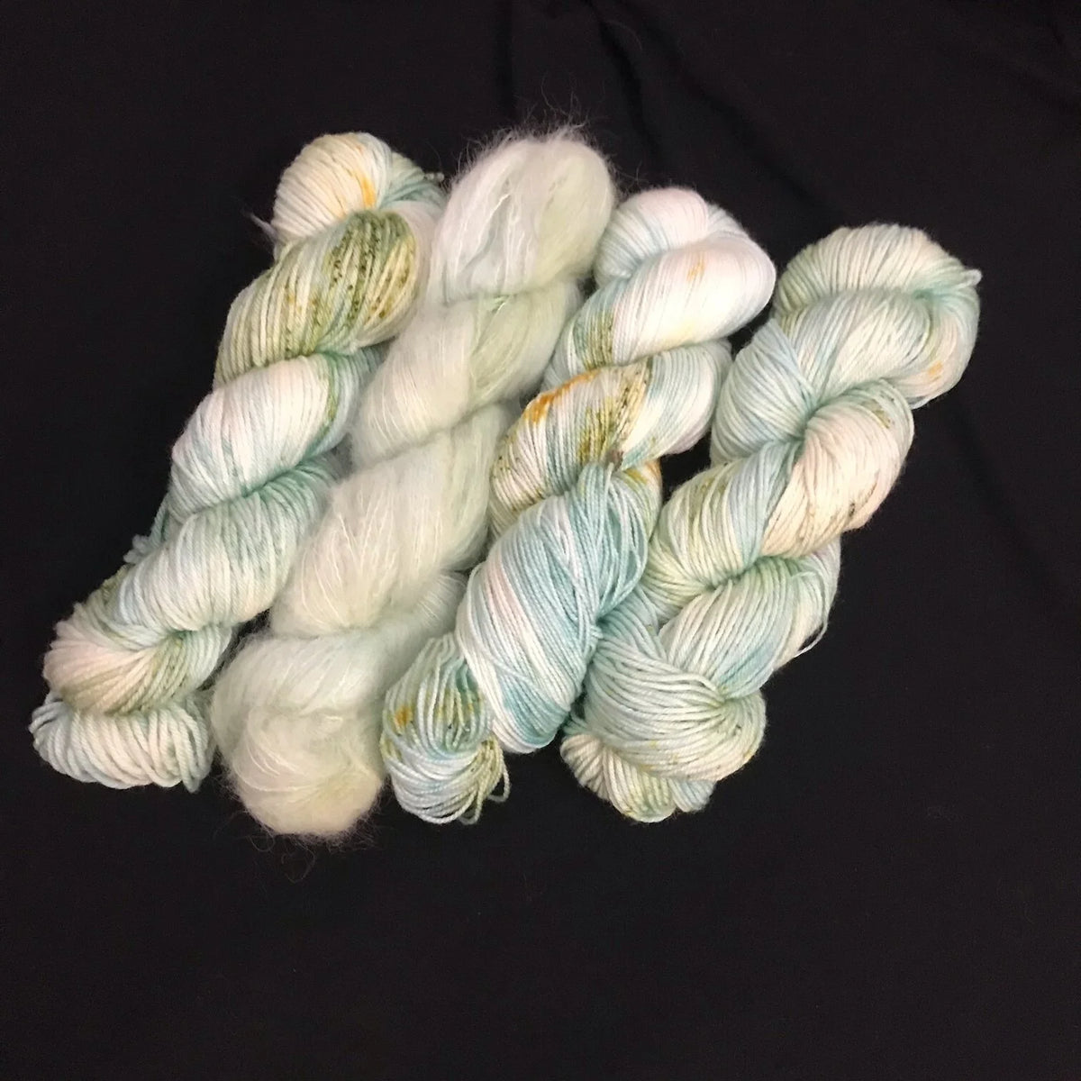 Soft Gnome Depot Fiber DK weight yarn in light green tones for knitting and crocheting projects