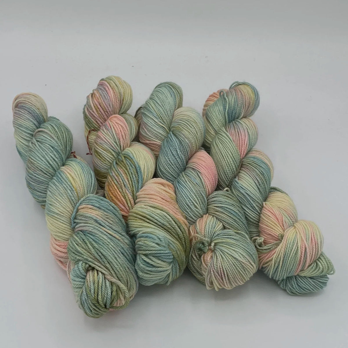 Multicolored skeins of Gnome Depot Fiber DK weight yarn perfect for knitting and crocheting projects