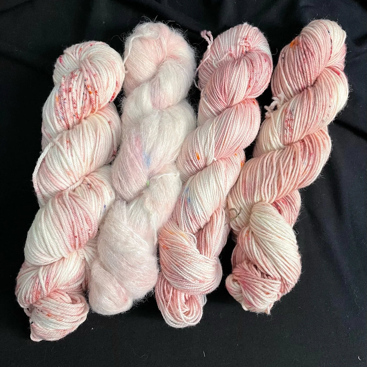 Gnome Depot Fiber DK weight yarn in soft pink tones with a blend of textures and fibers