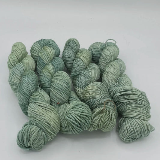Gnome Depot fingering weight yarn in soft green shades for knitting and crochet projects